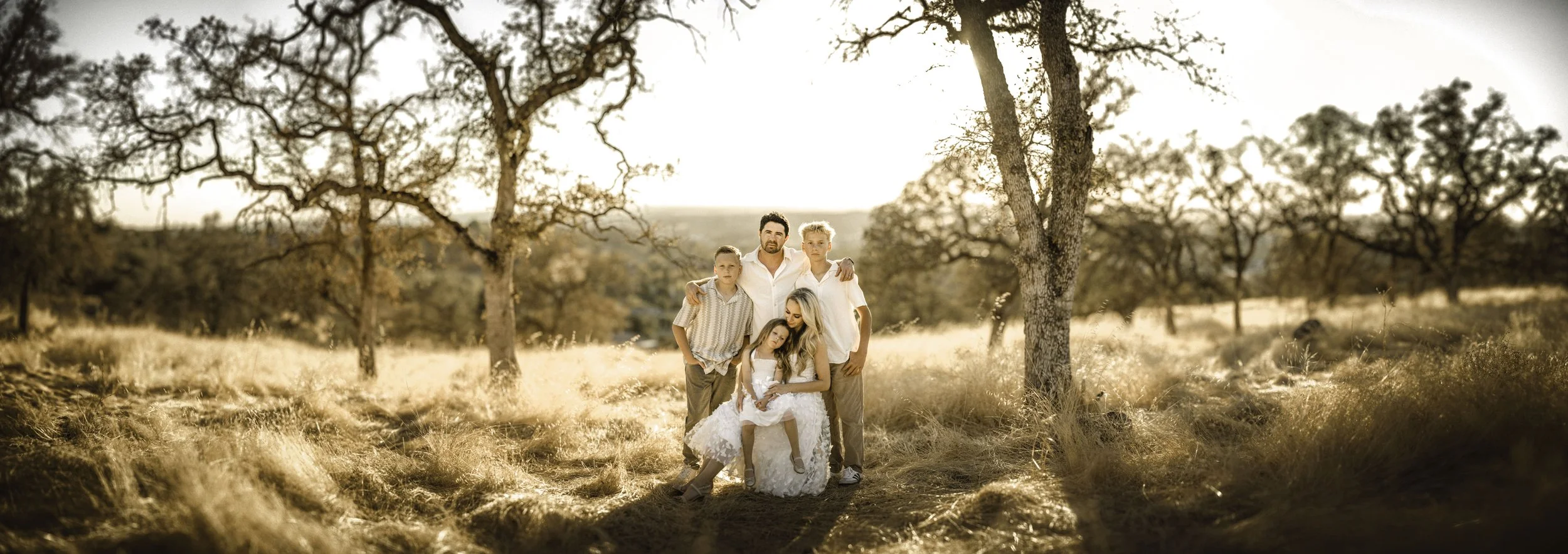 Family session in the Sierra Nevada foothills, low evening sun.